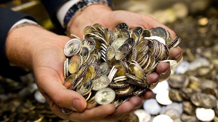 Zwei Hände voll neuer Zwei-Euro-Münzen.