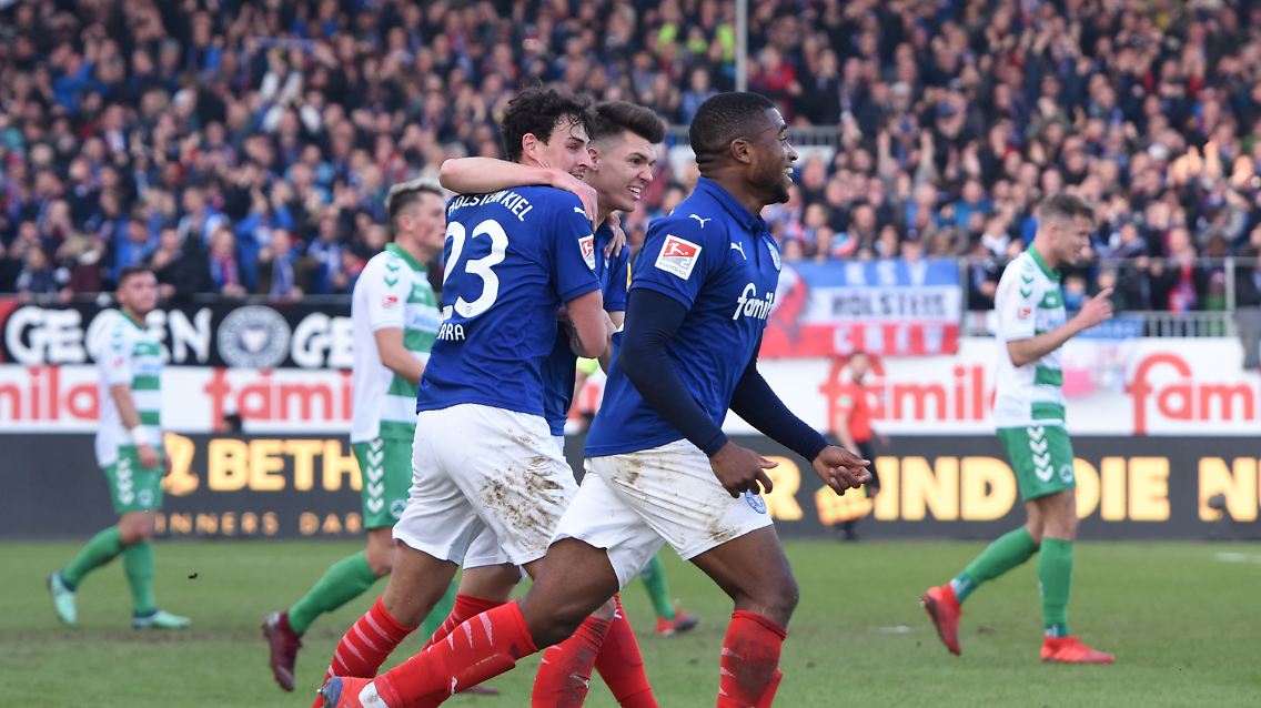 Die Kieler Janni Serra (l-r), Mathias Honsak und Franck Evina jubeln nach dem Tor zum 1:1.