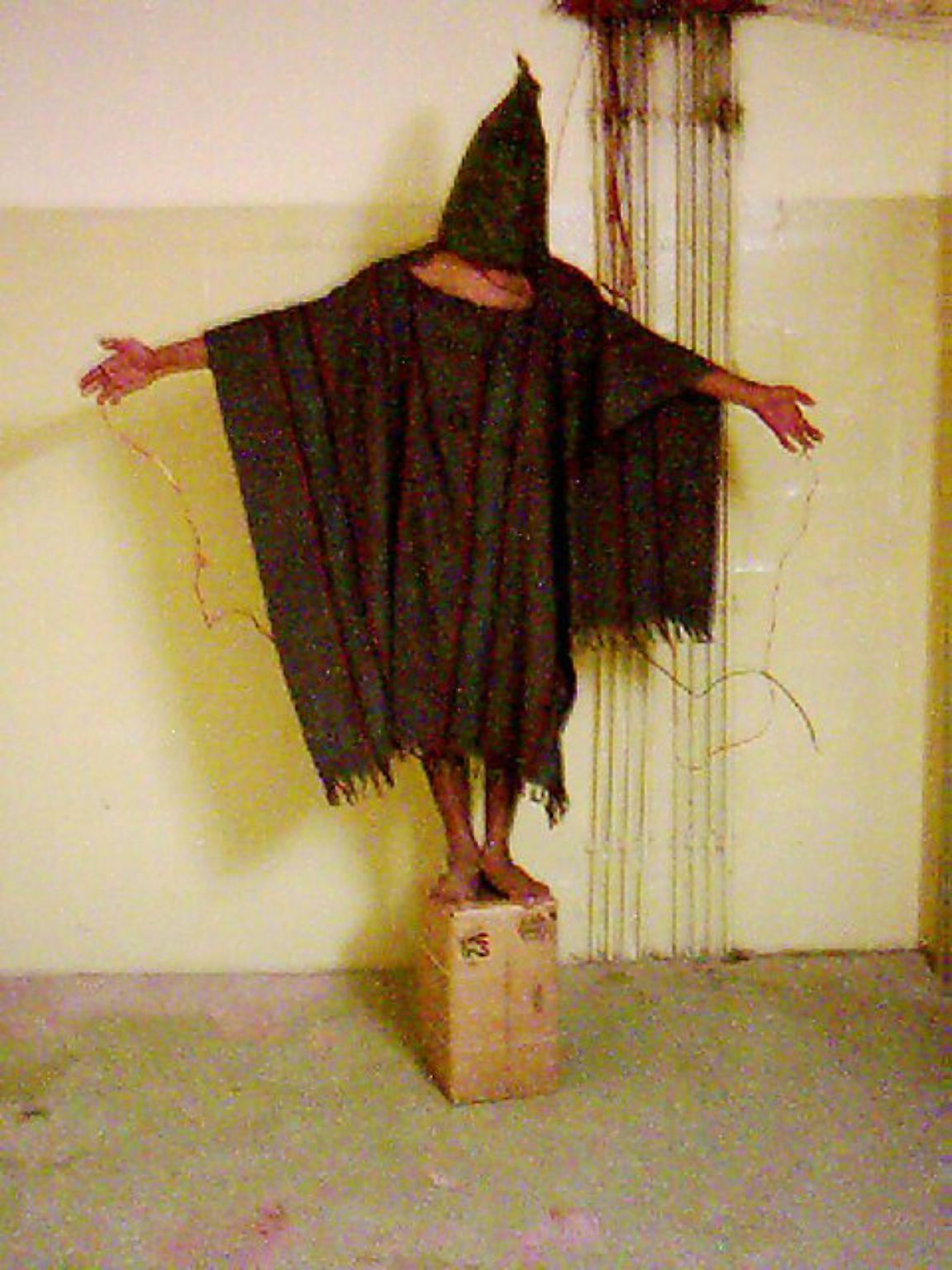 Am 28. April 2004 gehen schockierende Bilder um die Welt: Auf ihnen ist zu sehen, wie Angehörige des US-Wachpersonals während des Irak-Kriegs Häftlinge in Abu Ghraib foltern (wie hier bei einer Scheinhinrichtung), misshandeln ...