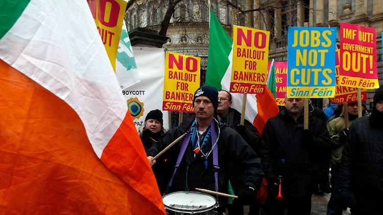 Vor dem Parlament demonstrieren Menschen gegen die Kürzungen.