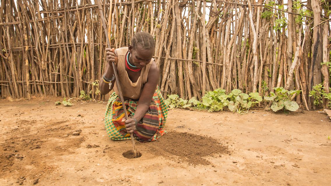 Munyes, 44, 'During my period I find it easy and very normal to make a hole in the ground and sit on top of it for blood to drain in it.' Karamoja Region, Uganda, September 2018.