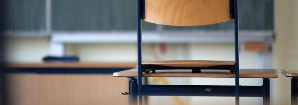 Ein Stuhl steht in einem Klassenzimmer auf einem Tisch. Foto: Marijan Murat/dpa/Archivbild