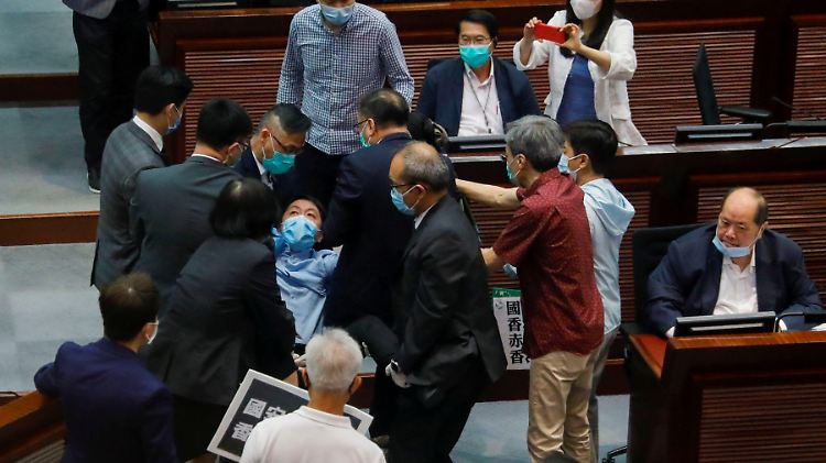 Pro-demokratische Abgeordnete protestierten gegen Chinas Vorhaben und wurden deshalb teilweise von Sicherheitskräften aus dem Hongkonger Parlament getragen.