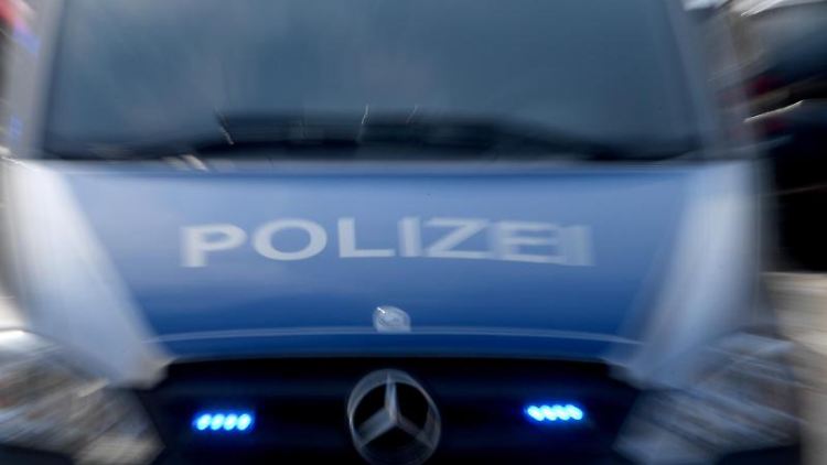 Die Polizisten tragen Schutzanzüge, als sie die Feier in Nordenham auflösen.