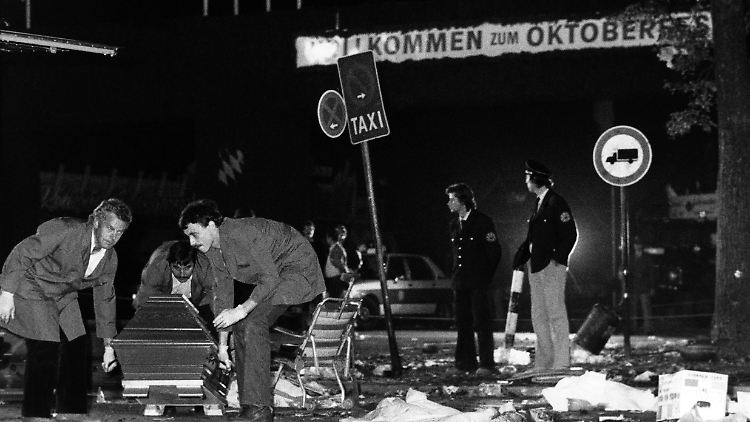 Ein Sarg wird vom verwüsteten Tatort beim Oktoberfest weggetragen.