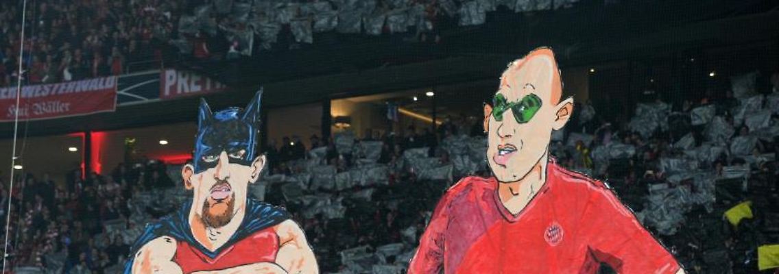 In einer Fan-Choreographie werden Darstellungen von Ribery (l) und Robben als Badman & Robben auf einem Transparent gezeigt. Foto: Tobias Hase/dpa/Archivbild