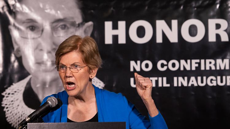 Die Demokratin Elizabeth Warren spricht vor einem Plakat zu Ehren Ginsburgs das fordert, erst nach der Wahl einen Kandidaten zur Abstimmung zu stellen.