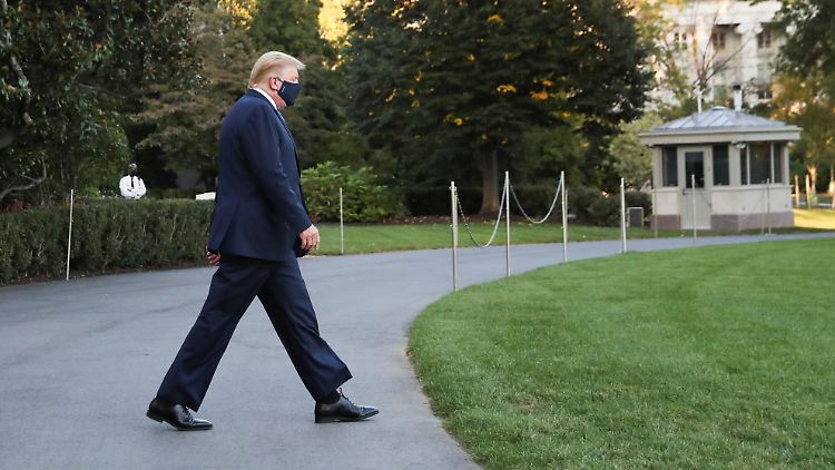 Trump - mit Maske - auf dem Weg zum Helikopter, der ihn kurz darauf ins Militärkrankenhaus bringt.