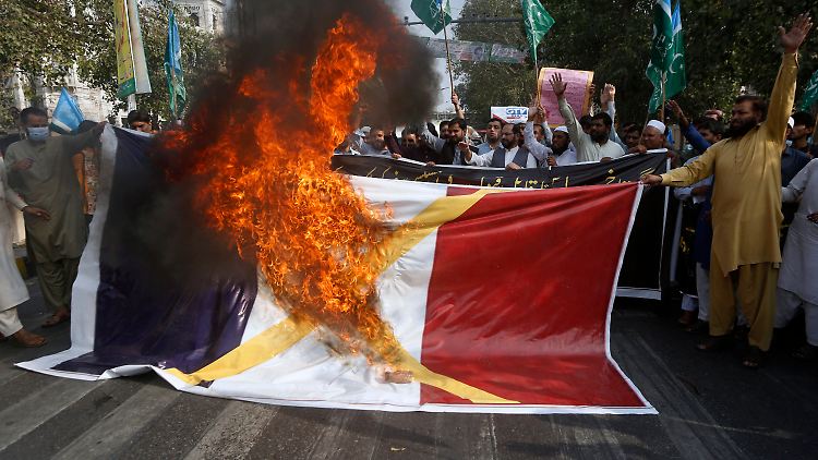 Demonstranten in Lahore verbrennen eine Frankreich-Flagge.