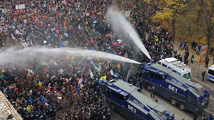 Vor dem Reichstag beregnete die Polizei mit Wasserwerfern Protestteilnehmer, um Masken verweigernde Demonstranten zu vertreiben.