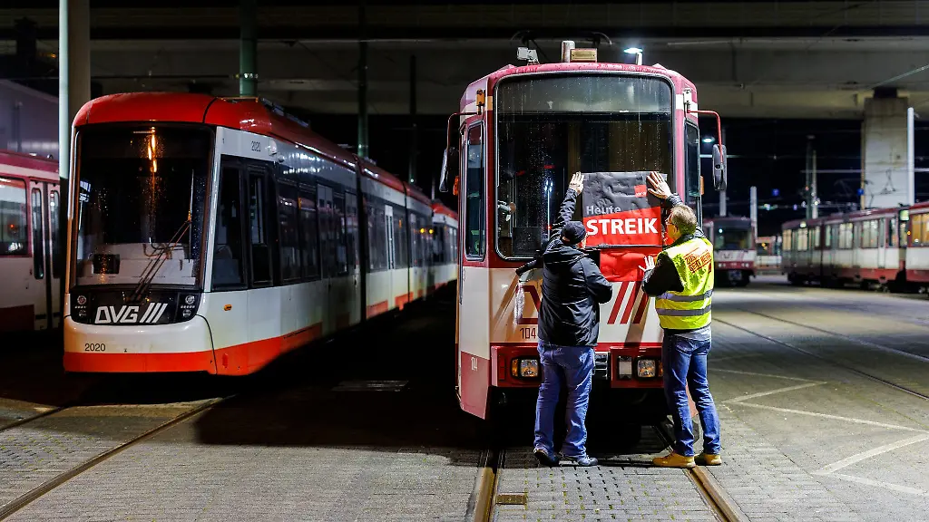 Heute-Streik-steht-auf-dem-Plakat-dass-Beschaeftigte-in-Duisburg-am-fruehen-Morgen-an-eine-Strassenbahn-haengen