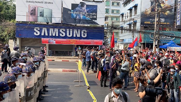 In Myanmars größter Stadt Yangon stehen sich Polizisten und Demonstranten gegenüber. 