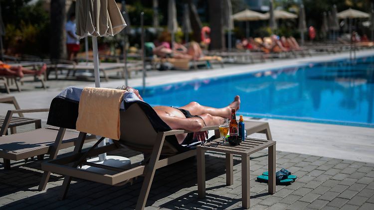 Ein Mann entspannt am Pool in einem Riu-Hotel auf Mallorca.