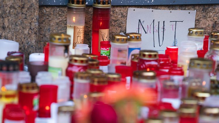 Mit Kerzen erinnern Menschen an die drei getöteten Frauen.