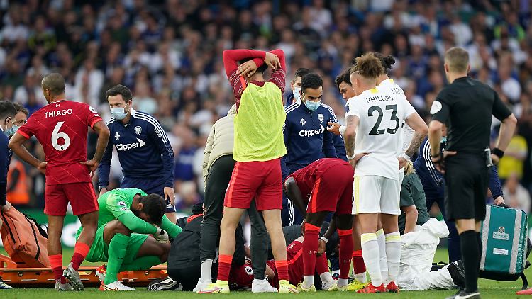 Geschockt stehen die Spieler beider Mannschaften bei Harvey Elliott.