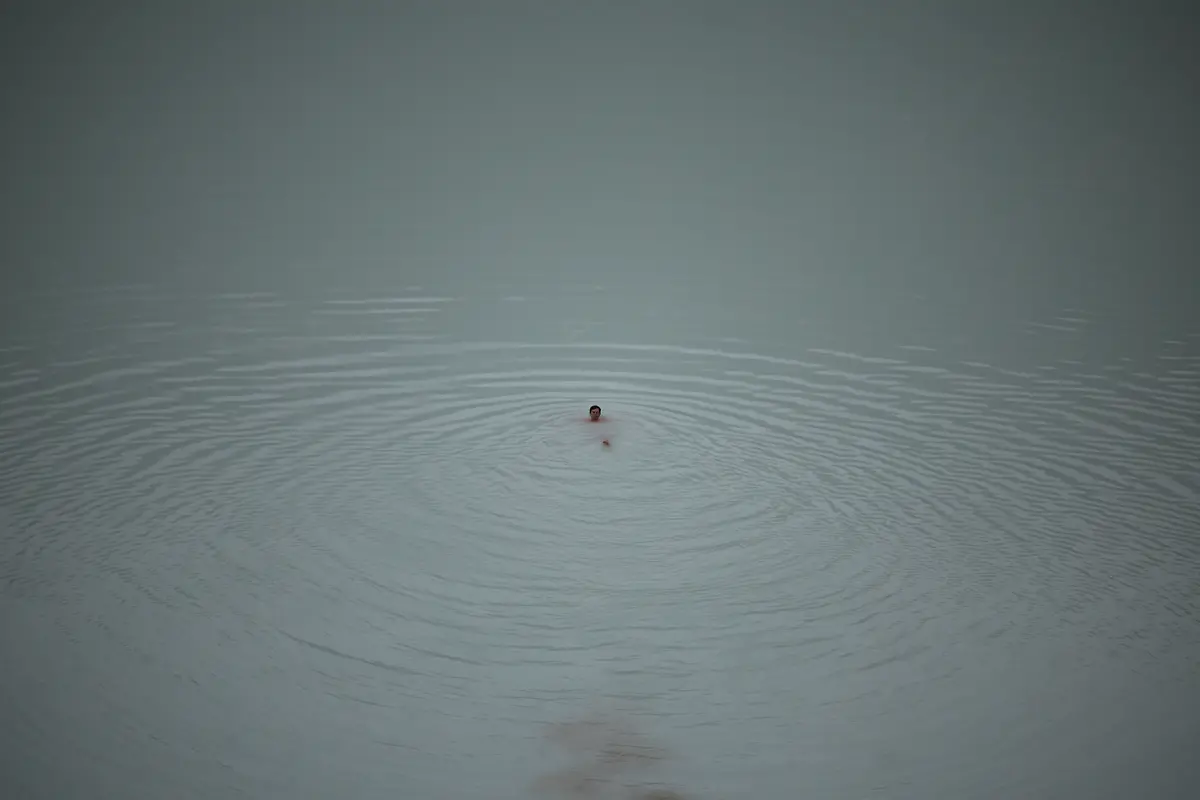 A-tourist-swims-in-the-Viti-crater-lake-at-the-Askja-volcano