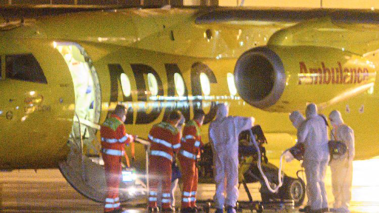 Einer von zwei Corona-Patienten wird in der Nacht auf dem Flughafen Dresden International von Rettungskräften in ein ADAC Ambulanz Flugzeug verladen, um nach Bremen ausgeflogen zu werden.