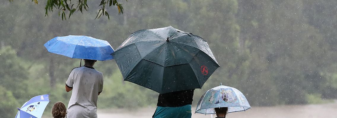 Eine Familie beobachtet das steigende Wasser in Goodna. Die Bewohner des Südostens von Queensland müssen mit heftigeren Regenfällen und lebensbedrohlichen Sturzfluten rechnen.