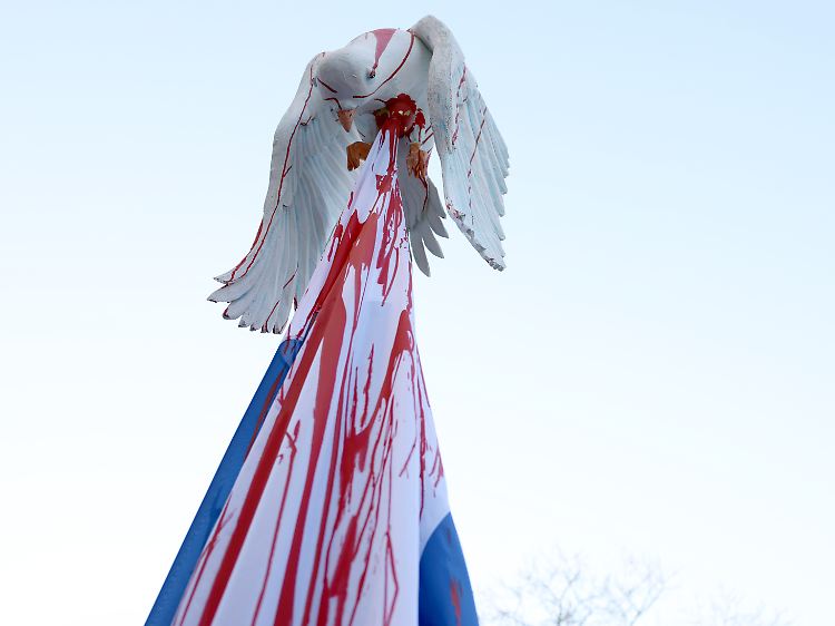 Eine Friedenstaube, aufgespießt von einer russischen Fahne, bei der Friedensdemonstration am Rosenmontag.