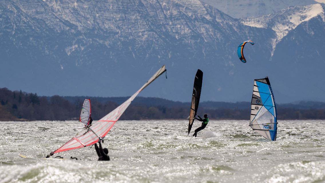 Hatten Spaß am windigen und verregneten April-Tag: Windsurfer auf dem Ammersee in Bayern.