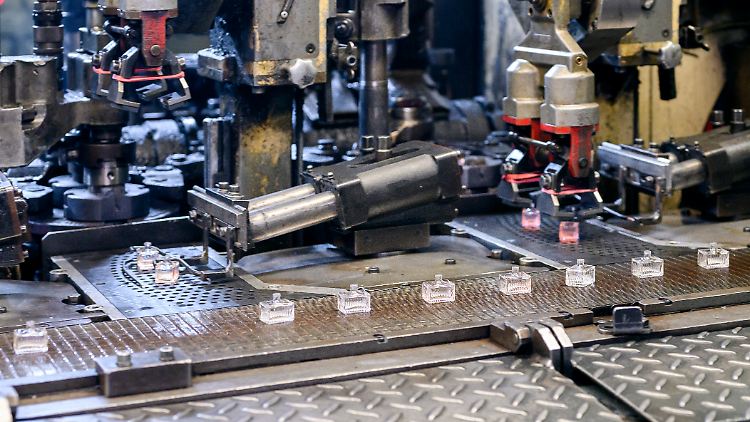 Roboter legen bei Heinz-Glas Flakons auf ein Förderband. 