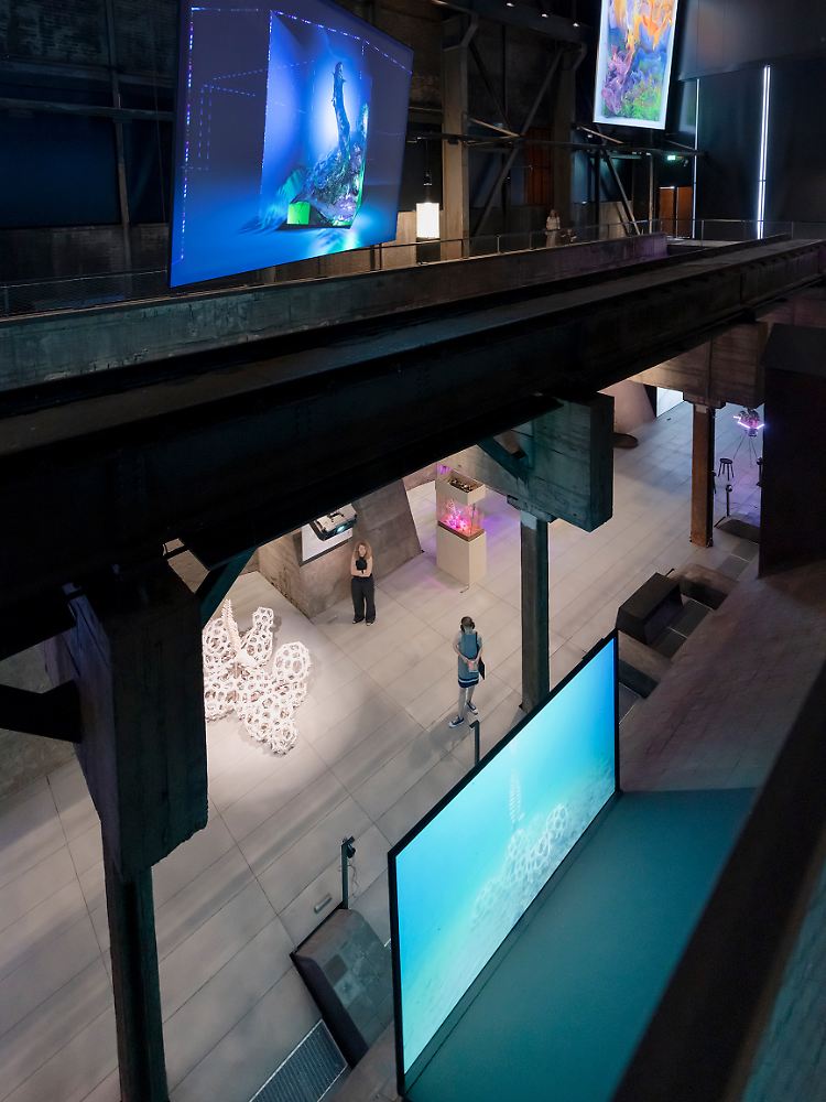 In alten Industriehallen visionäre Kunst, die sich mit dem ökologischen Wandel auseinandersetzt.