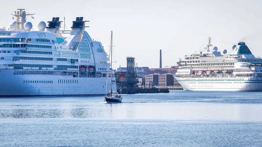 Das-Kreuzfahrtschiff-Amera-r-faehrt-beim-einlaufen-in-den-Hafen-an-der-Seabourn-Quest-l-vorbei