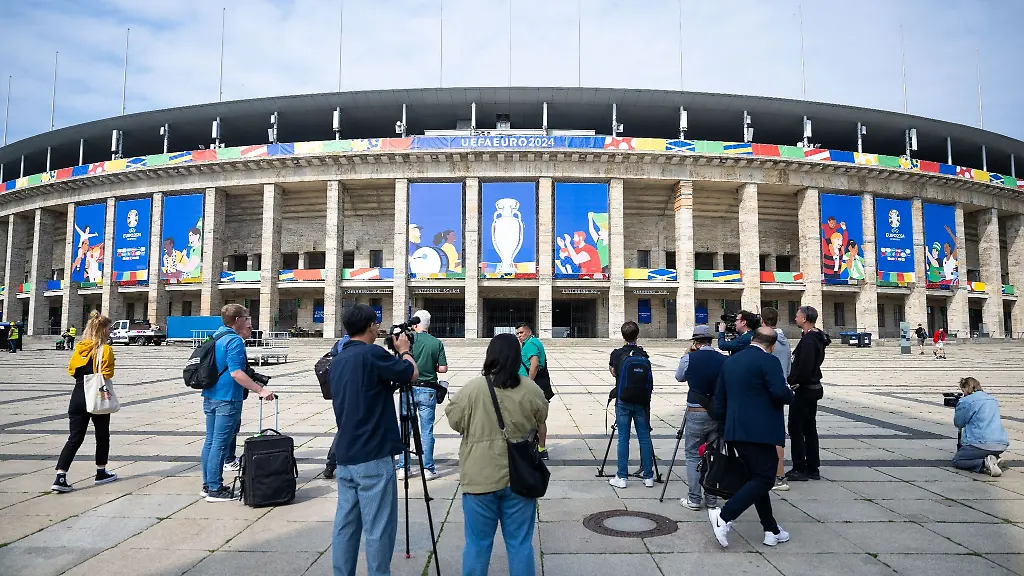 Pressevertreter-filmen-und-fotografieren-das-Olympiastadion-das-fuer-die-UEFA-EURO-2024-geschmueckt-ist