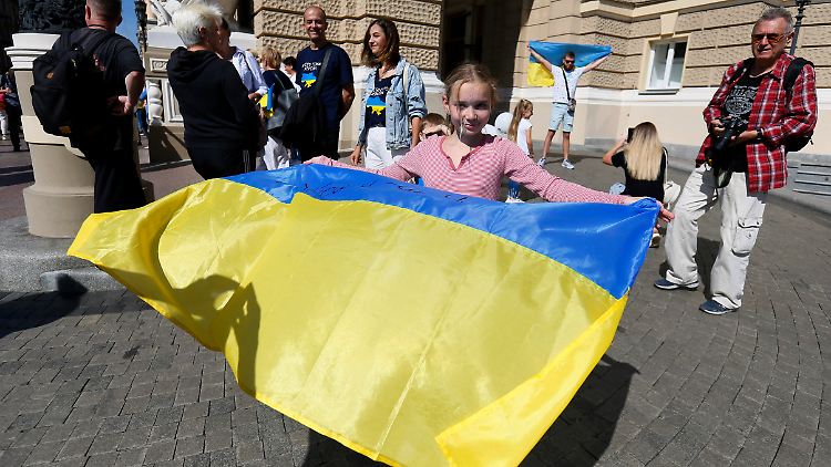 Ein Mädchen aus Cherson hält eine ukrainische Nationalflagge während einer Kundgebung in Odessa.