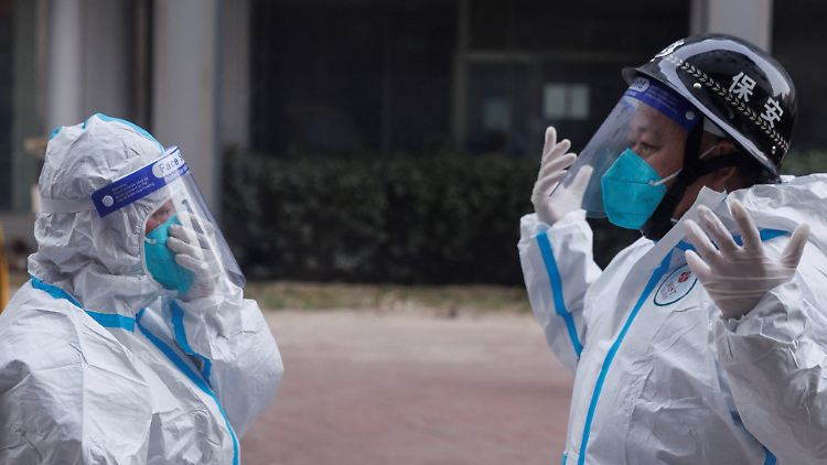 Wurden zum Symbol für Chinas harte Corona-Maßnahmen: Menschen in weißen Schutzanzügen, die etwa auf die Einhaltung der Quarantäne-Regeln achten.