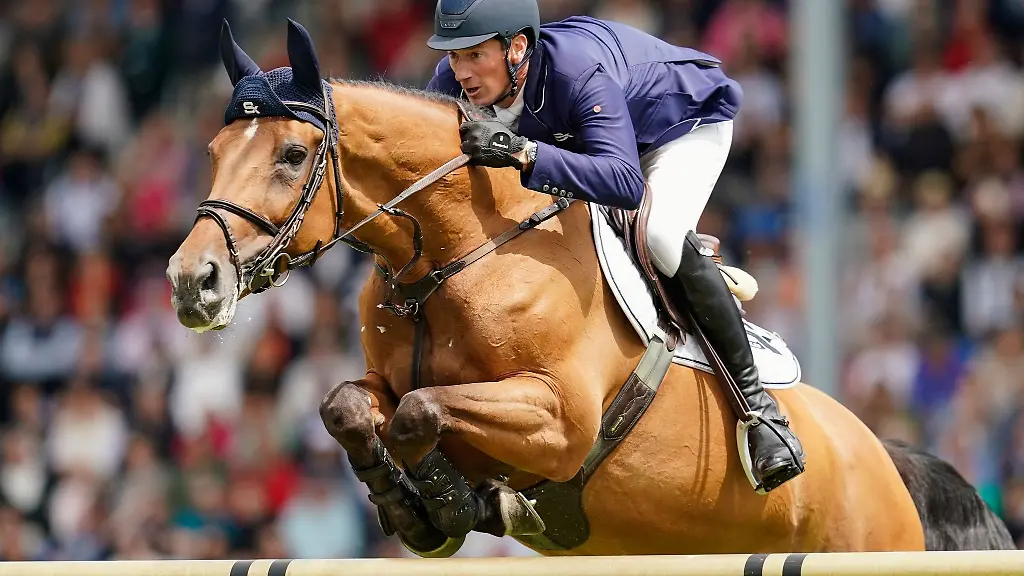 Der-Springreiter-Daniel-Deusser-aus-Deutschland-springt-auf-einem-Pferd-ueber-ein-Hindernis