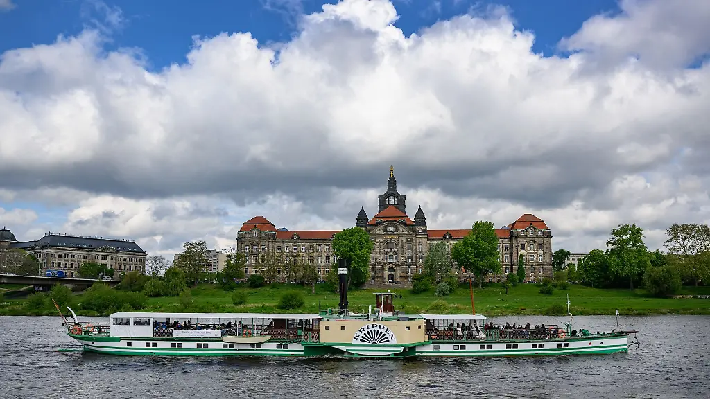 Der-historische-Schaufelraddampfer-Krippen-der-Saechsischen-Dampfschifffahrt-faehrt-am-Vormittag-auf-der-Elbe-vor-der-Staatskanzlei-entlang