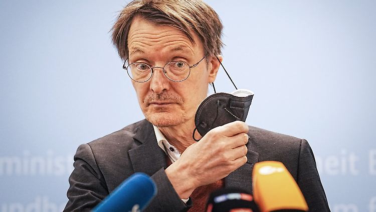 Bundesgesundheitsminister Karl Lauterbach setzt eine Schutzmaske ab. 