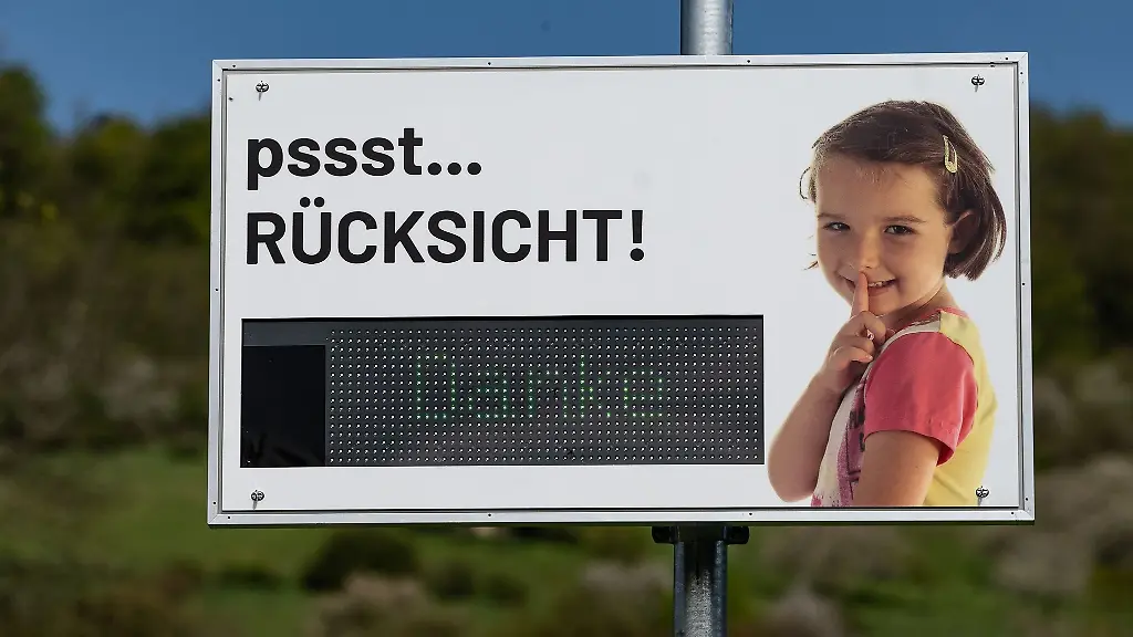 Ein-Laermdisplay-mit-der-Aufschrift-pssst-Ruecksicht-Danke-steht-an-einem-Ortseingang