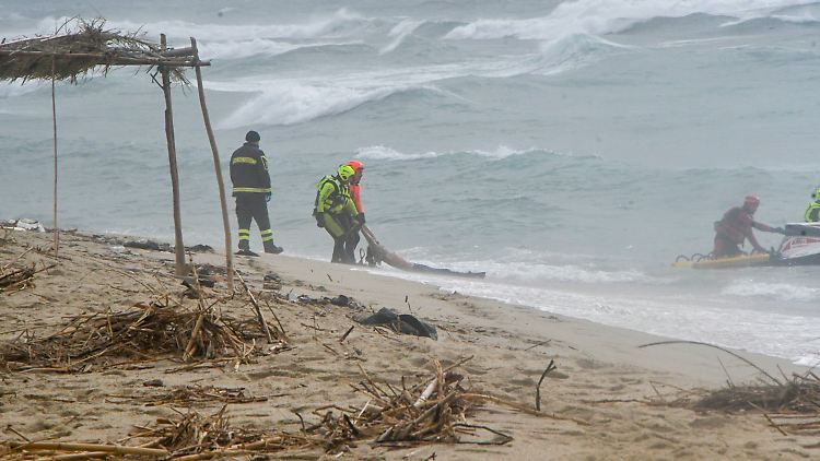 Retter ziehen bei Cutro einen Leichnam aus dem Meer.