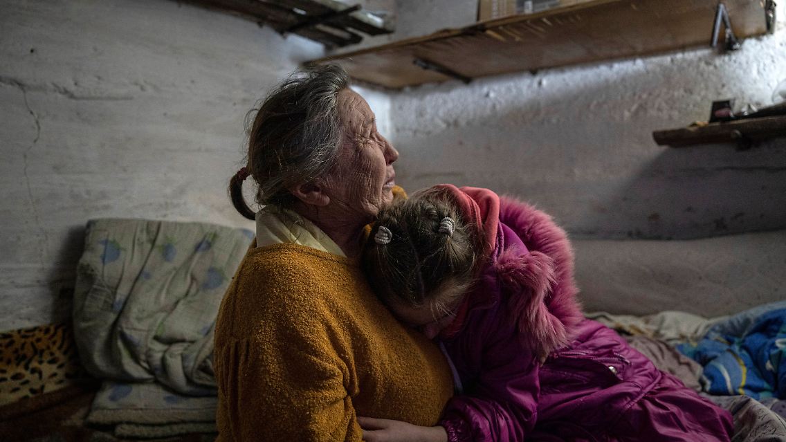 In dem Dorf Bohojawlenka in der Oblast Donezk suchen eine Großmutter und ihre Enkelin im Keller ihres Hauses Schutz vor dem Beschuss.