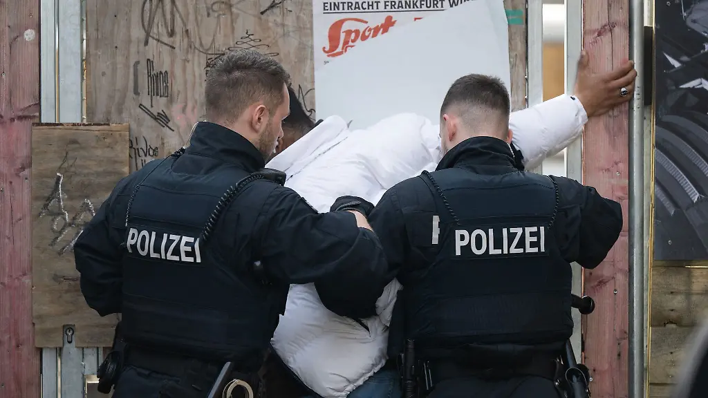 Polizisten-durchsuchen-im-Rahmen-einer-Grosskontrolle-im-Bahnhofsviertel-von-Frankfurt-am-Main-Verdaechtige
