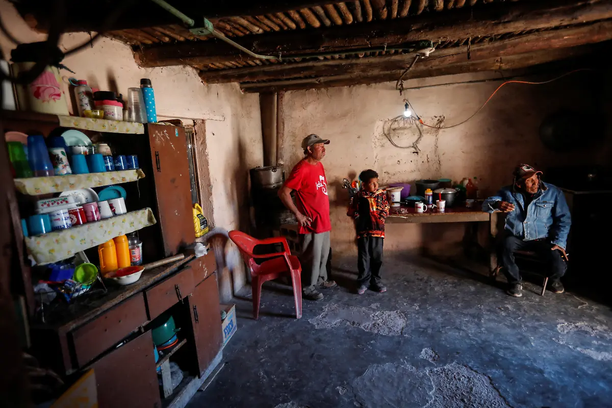 The-wax-producer-Arnulfo-Ramirez-spends-time-with-his-son-and-a-friend-inside-his-home