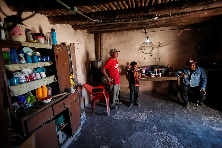 The-wax-producer-Arnulfo-Ramirez-spends-time-with-his-son-and-a-friend-inside-his-home