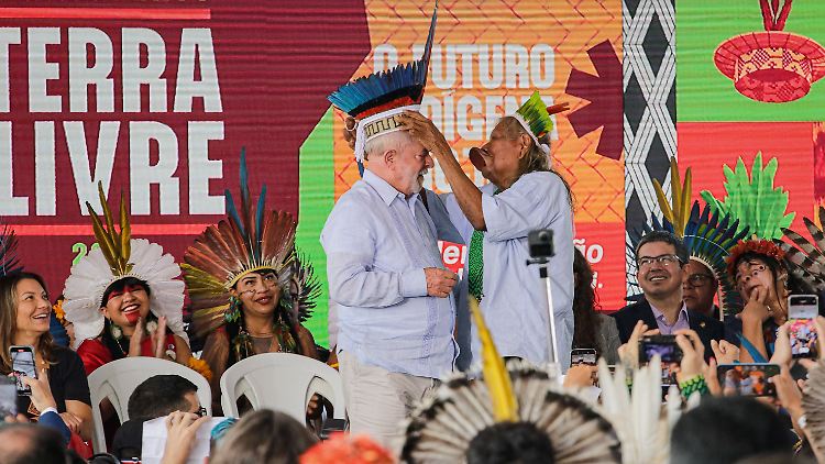 Kaiapo-Häutpling Raoni Metuktire setzt dem brasilianischen Präsidenten Luiz Inacio Lula da Silva eine Federkrone auf.