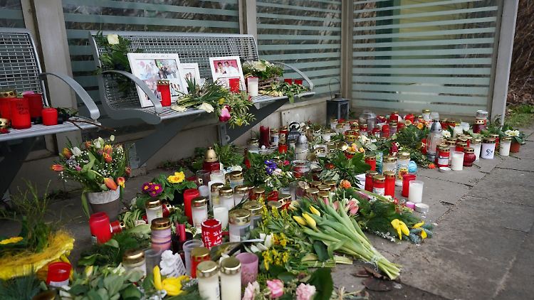 Kerzen und Blumen stehen und liegen im Bahnhof Brokstedt in einem Wartehäuschen.