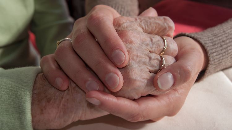 Kaum jemand möchte alleine sterben: Eine Frau hält die Hand einer älteren Dame. (Symbolbild)