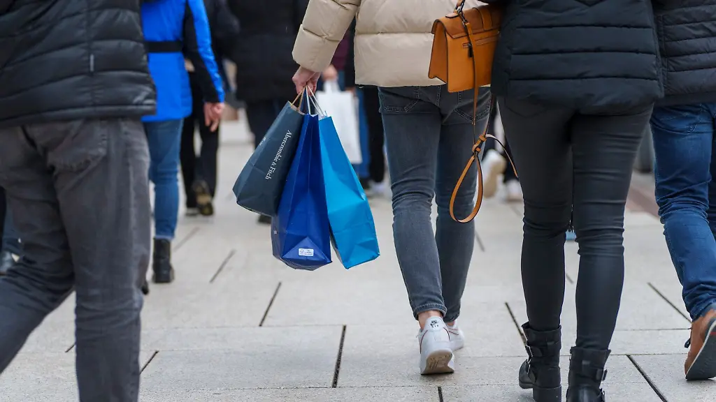 Ein-Mann-geht-mit-Einkaufstueten-auf-der-Zeil-in-Frankfurt