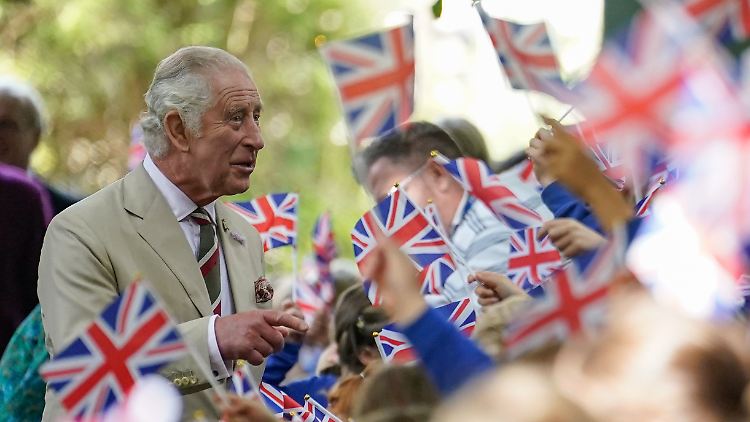 König Charles trifft auf Fähnchen wedelnde Schulkinder in Wales.