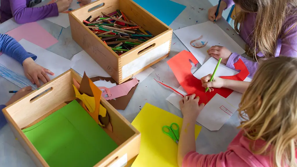 Grundschuelerinnen-sind-in-einem-Kinderhort-mit-Bastelarbeiten-beschaeftigt