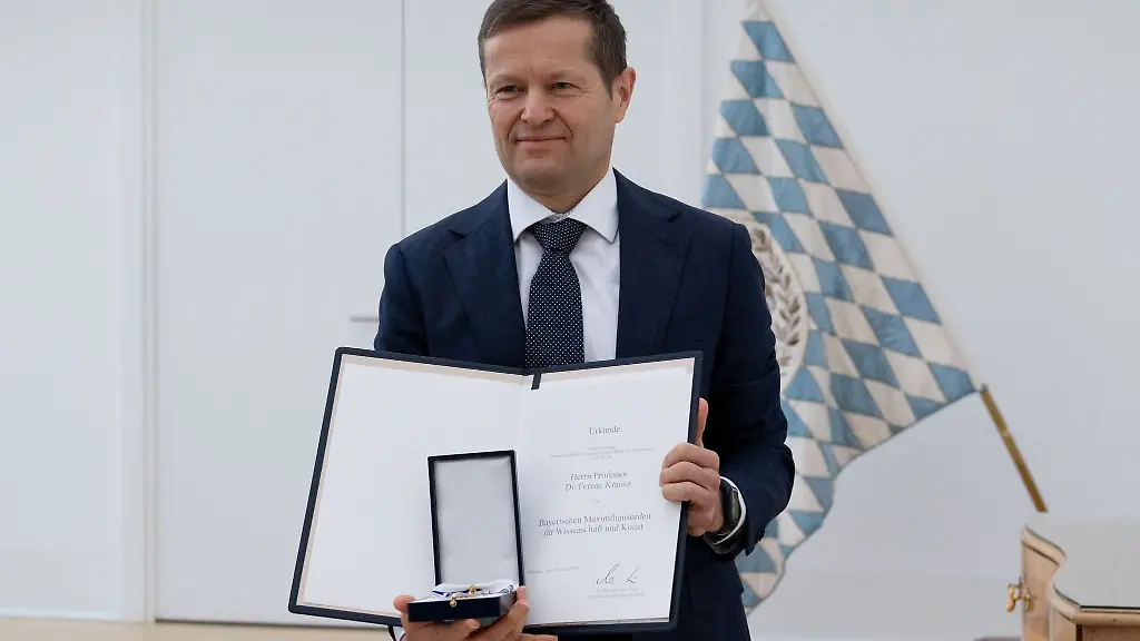 Ferenc-Krausz-Physiker-und-Nobelpreistraeger-von-2023-zeigt-nach-der-Verleihung-des-bayerischen-Maximiliansordens-fuer-Wissenschaft-und-Kunst-durch-den-bayerischen-Ministerpraesidenten-Soeder-CSU-Auszeichnung-und-Urkunde