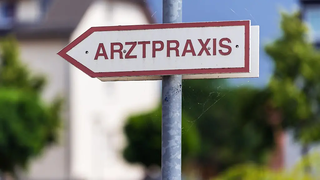 Ein-Schild-Arztpraxis-steht-an-der-Strasse