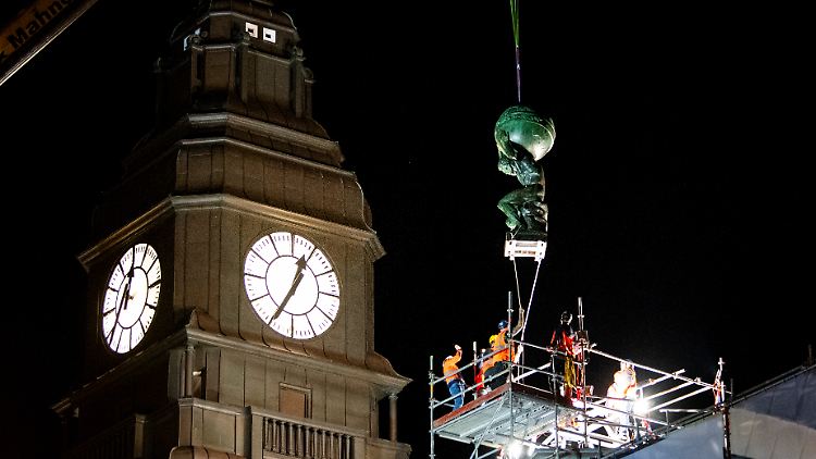 Die Atlas-Skulptur wird am Hamburger Hauptbahnhof mit einem Kran auf das Dach gehoben.