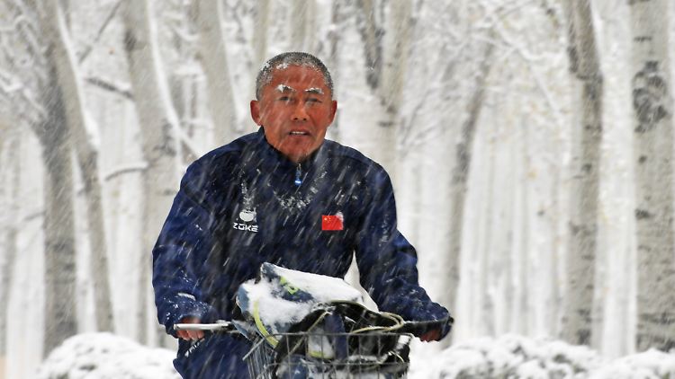 Ein Mann fährt trotz Temperaturen unter dem Gefrierpunkt mit dem Roller durch das nordchinesische Shenyang.