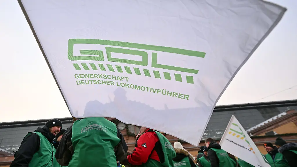 Mitglieder-der-Lokfuehrergewerkschaft-GDL-stehen-mit-Fahnen-vor-dem-Erfurter-Hauptbahnhof